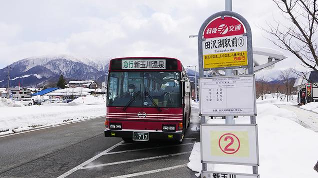 新玉川温泉行きの赤い急行バスがバス停に到着